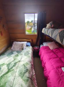 Postel nebo postele na pokoji v ubytování Hospedaje Familiar Refugio Coihuin