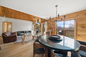 a dining room and living room with a glass table at Sugar View Chalet in Banner Elk