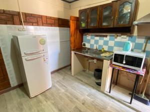 a small kitchen with a refrigerator and a sink at Apartamentos Quintana in Santa María