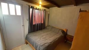 a small bed in a small room with a window at Casa Familia Mateo in Santa Teresita