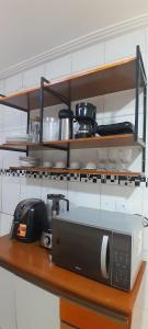 a microwave sitting on a counter in a kitchen at Villa Hostel in Belém