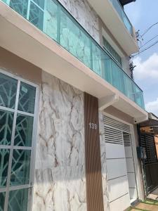 a facade of a house with a stone wall at Villa Hostel in Belém