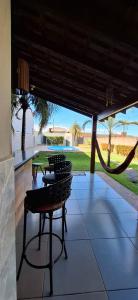 a patio with a table and chairs and a hammock at Casa de Bonito in Bonito