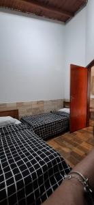 a room with two beds and a door at Casa de Bonito in Bonito