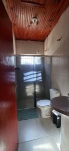 a bathroom with a shower and a toilet and a sink at Casa de Bonito in Bonito +4 photos