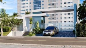 a car parked in a parking lot in front of a building at Cond Millenium residênce in Juiz de Fora