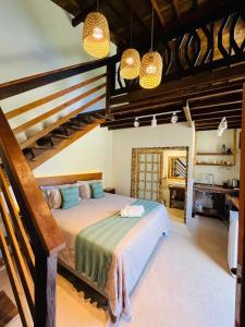 a bedroom with a large bed in a room at Cabana na Natureza Com Hidro - Baoba Suites in Bombinhas +21 photos