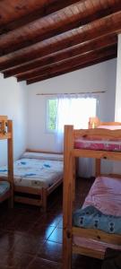 a room with two bunk beds and a window at Luana2 in Villa Gesell