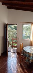 a room with a table and a view of a balcony at Luana2 in Villa Gesell +5 photos