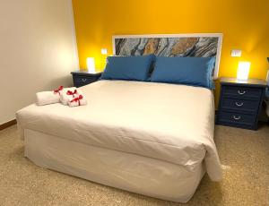 マリーナ・ディ・ピサにあるDomus Libeccio 57の大きな白いベッドと青い枕のある寝室