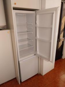 a white refrigerator with its door open in a kitchen at Stylish Cacilhas rooms near the ferry to central Lisbon in Almada +28 photos