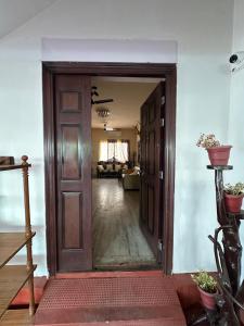 an open door into a room with a living room at Rose villa in Coimbatore +2 photos