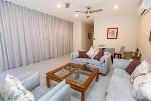 a living room with two couches and a coffee table at Casa Itzae Hotel Boutique in Mérida