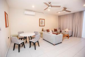 a living room with a table and chairs at Casa Itzae Hotel Boutique in Mérida