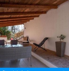 a living room with a couch and a table and chairs at Holiday Home Nature Plesivica in Jastrebarsko