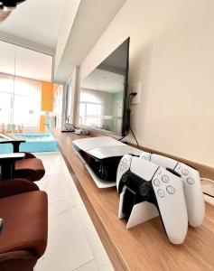a room with two video game controllers on the floor at NOVIDADE! Apartamento Bella Vita Bertioga in Bertioga +64 photos