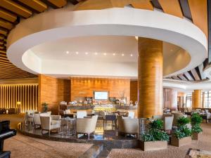 a lobby of a hotel with tables and chairs at Swissôtel Living Al Ghurair Dubai - Deira - Apartments in Dubai