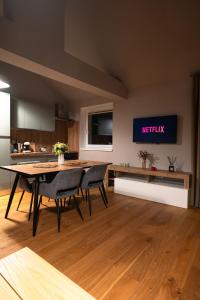 a kitchen and dining room with a table and chairs at The Nest Beneath the Citadel - 5 min to City Square in Râşnov