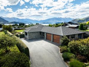 an aerial view of a house with a driveway at Beacon Point Lakeview Escape - Spacious - Stylish in Wanaka