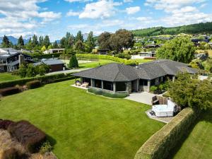 an aerial view of a house with a large yard at Beacon Point Lakeview Escape - Spacious - Stylish in Wanaka