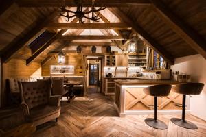 an attic kitchen with wooden ceilings and wooden floors at Deer Apartment in Lipí +31 photos
