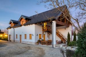a white house with a black roof at Deer Apartment in Lipí