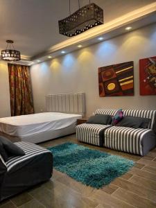 a bedroom with two beds and a rug at Stella Heights in El Alamein