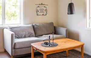 a living room with a couch and a coffee table at Stunning Home In Myggenäs With Sauna in Höviksnäs