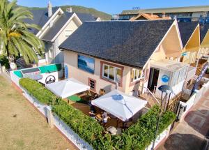een luchtzicht op een huis met tafels en parasols bij Waves Sound Surf House Completo in Santoña