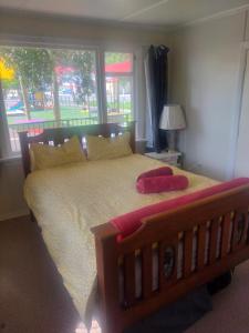 a bedroom with a large bed with a large window at The Batch in Lawrence +12 photos