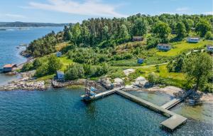 an island with a dock in the water at Cozy Home In Myggenäs With Sauna in Höviksnäs +14 photos