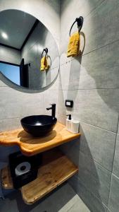a bathroom with a sink and a mirror at Casa Mosaiko Sonsón in Sonsón