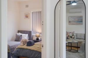 ein Schlafzimmer mit einem Bett, auf dem ein Teddybär liegt in der Unterkunft Family Friendly - 5 Mins To Beach in Belmont