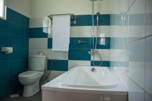 a bathroom with a tub and a toilet and a sink at Fortbella Tourist Inn in Njara +33 photos