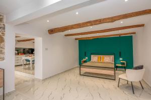 a bedroom with a green wall and a bed at Huzuri Retreat in Ayiós Nikólaos