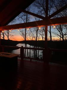 een zonsondergang vanaf de veranda van een hut bij Panoramic Point--PERFECT views of Rough River in Falls of Rough