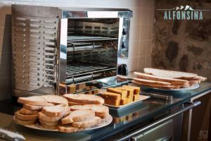 a bakery with bread on plates on a counter at Hotel La Alfonsina in Santibáñez de Villacarriedo
