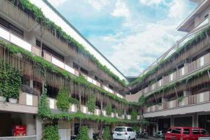 a building with plants growing on the side of it at Hotel Lestari Near Lippo Plaza Mall Jember in Jember