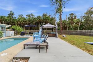 a blue chair sitting on a bench next to a pool at Crystal Blue Haven in Crystal River