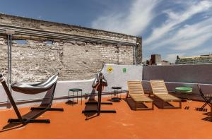 a group of chairs and tables on a roof at Hostal CASA MX bellas artes in Mexico City
