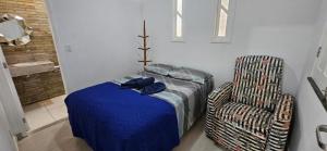 a bedroom with a bed and a chair at Casa Harmonia in Aracaju +13 photos