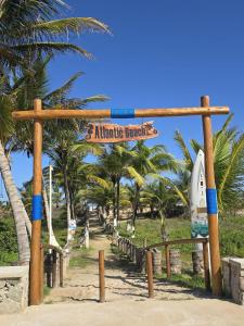 a minute markers sign on a beach with palm trees at Casa Harmonia in Aracaju