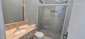 a bathroom with a toilet and a sink and a shower at Casa Harmonia in Aracaju +12 photos