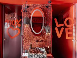 a shop window with a mirror and a love sign at 25hours Hotel Florence Piazza San Paolino in Florence +89 photos
