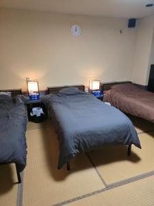 Postel nebo postele na pokoji v ubytování business hotel furusatoビジネスホテルふるさと
