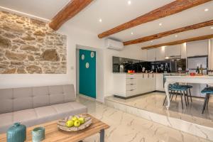 a living room and kitchen with a couch and a table at Huzuri Retreat in Ayiós Nikólaos