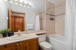 a bathroom with a sink and a toilet and a tub at 2BR Very Spacious Townhome in a Great Location by Harmony Whistler in Whistler +47 photos