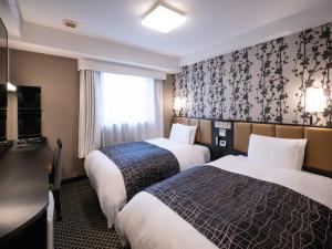 Postel nebo postele na pokoji v ubytování APA Hotel Sugamo Ekimae