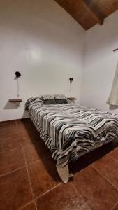 Ένα ή περισσότερα κρεβάτια σε δωμάτιο στο Cabañas Don Emilio