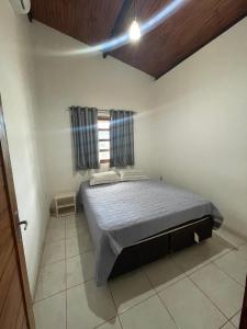 a bedroom with a bed in a room with a window at Morada do vento in São Miguel do Gostoso +4 photos